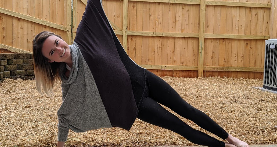 A woman in side plank position demonstrating working from home.